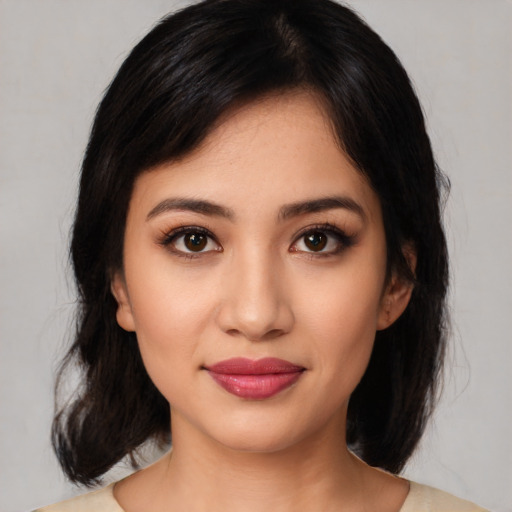 Joyful latino young-adult female with medium  black hair and brown eyes