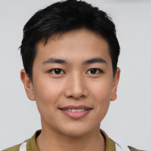 Joyful asian young-adult male with short  brown hair and brown eyes