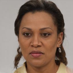 Joyful black adult female with medium  brown hair and brown eyes