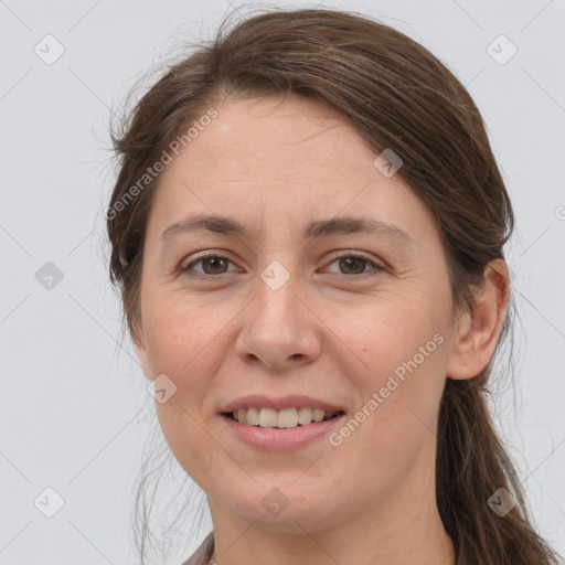 Joyful white young-adult female with long  brown hair and grey eyes