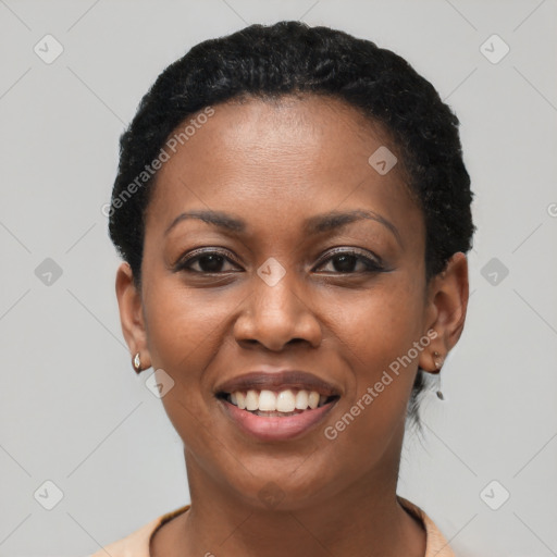 Joyful black young-adult female with short  black hair and brown eyes