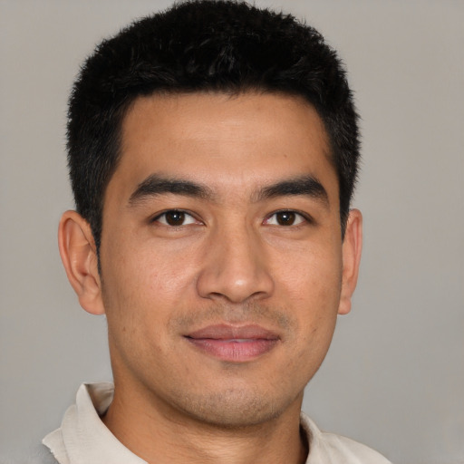 Joyful asian young-adult male with short  black hair and brown eyes