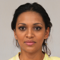 Joyful black young-adult female with medium  brown hair and brown eyes