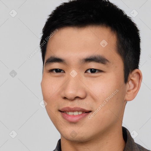 Joyful asian young-adult male with short  black hair and brown eyes