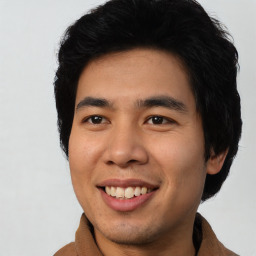 Joyful asian young-adult male with short  black hair and brown eyes