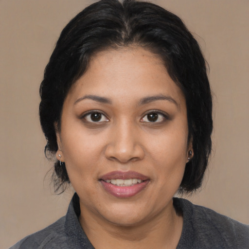 Joyful latino young-adult female with medium  black hair and brown eyes