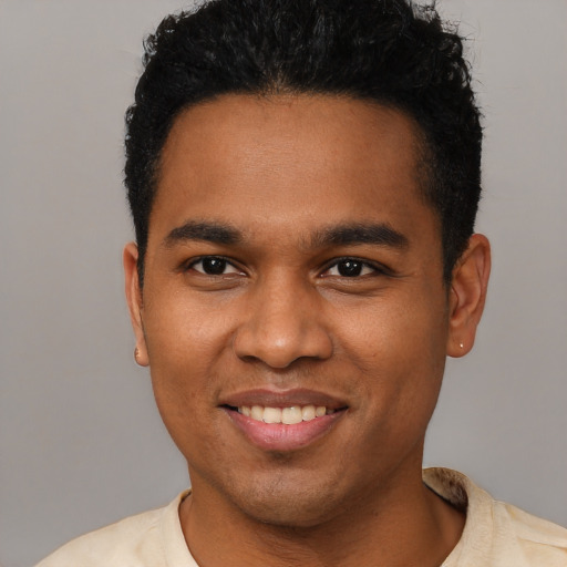 Joyful black young-adult male with short  black hair and brown eyes