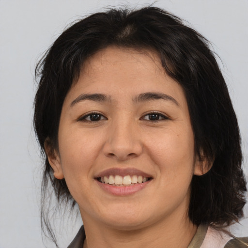 Joyful asian young-adult female with medium  brown hair and brown eyes