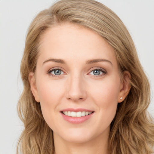 Joyful white young-adult female with long  brown hair and blue eyes