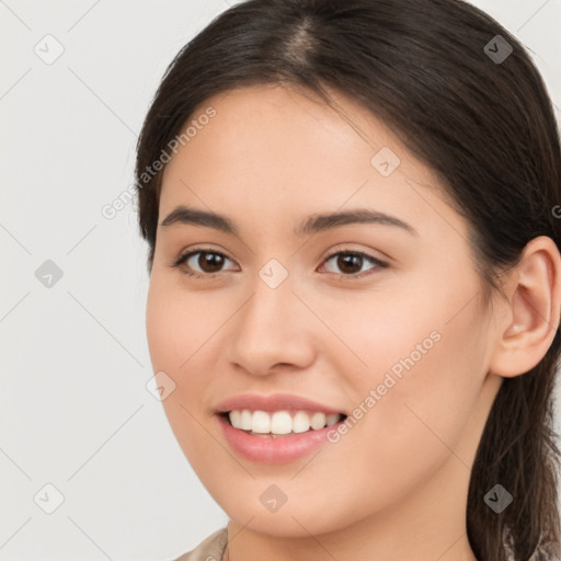 Joyful white young-adult female with long  brown hair and brown eyes