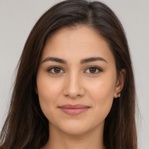 Joyful white young-adult female with long  brown hair and brown eyes
