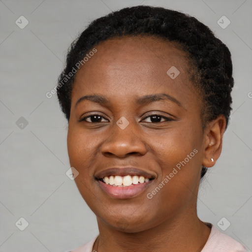 Joyful black young-adult female with short  black hair and brown eyes