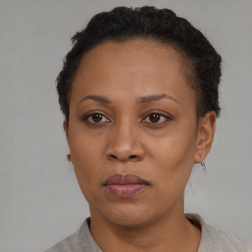 Neutral black adult female with short  black hair and brown eyes
