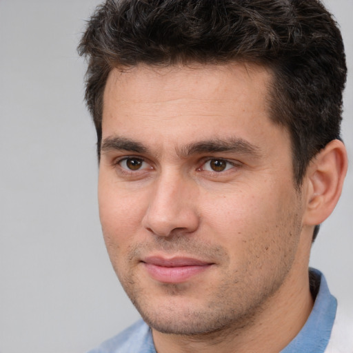 Joyful white young-adult male with short  brown hair and brown eyes