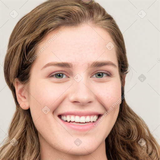 Joyful white young-adult female with long  brown hair and blue eyes