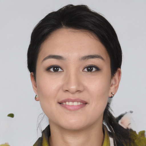 Joyful asian young-adult female with short  brown hair and brown eyes