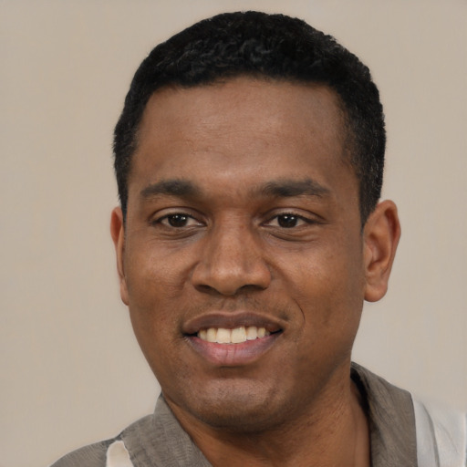 Joyful latino young-adult male with short  black hair and brown eyes