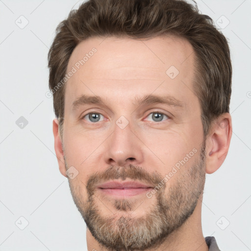 Joyful white adult male with short  brown hair and grey eyes