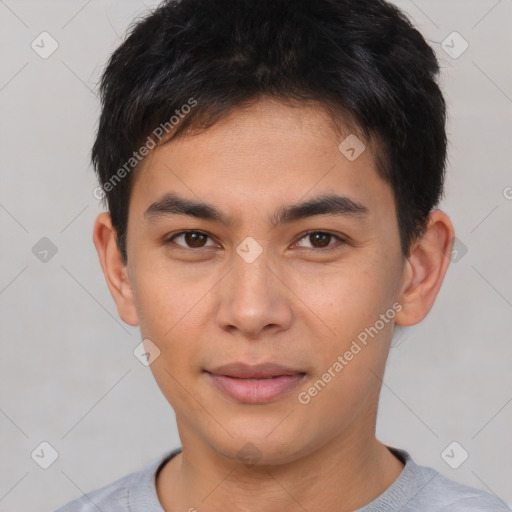 Joyful asian young-adult male with short  brown hair and brown eyes