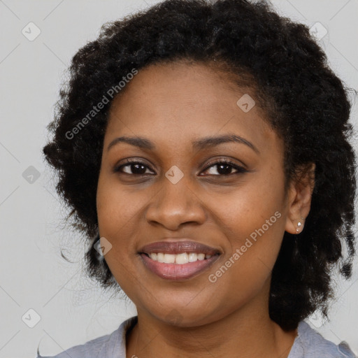 Joyful black young-adult female with long  brown hair and brown eyes