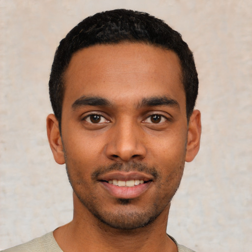 Joyful latino young-adult male with short  black hair and brown eyes