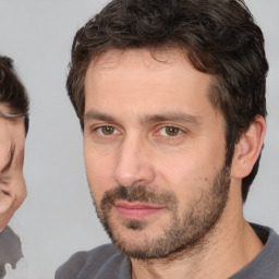 Joyful white adult male with short  brown hair and brown eyes