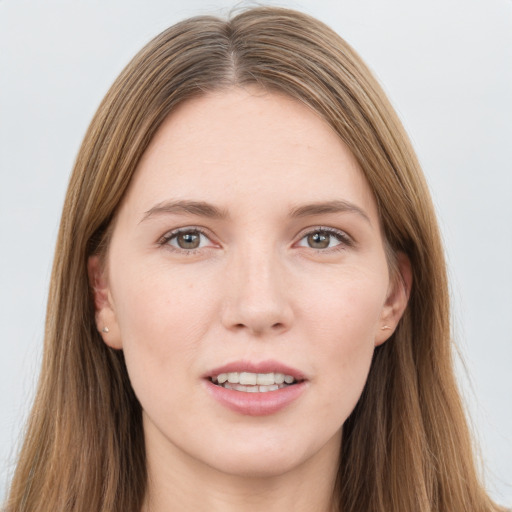 Joyful white young-adult female with long  brown hair and grey eyes