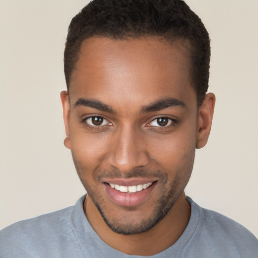 Joyful black young-adult male with short  brown hair and brown eyes