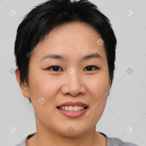 Joyful asian young-adult female with short  brown hair and brown eyes