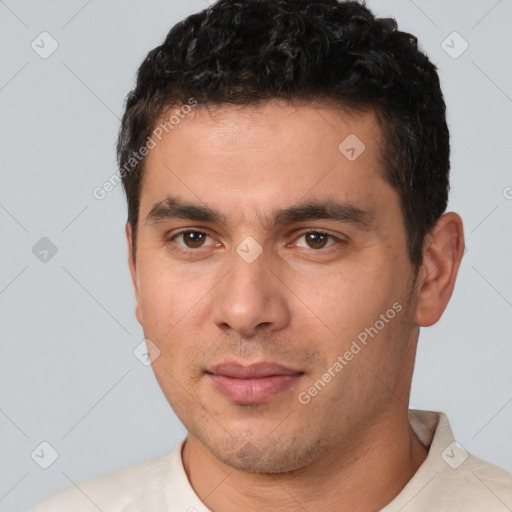 Joyful white young-adult male with short  black hair and brown eyes