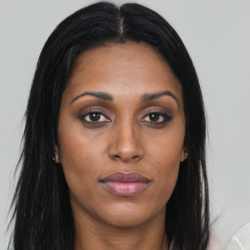 Joyful asian young-adult female with long  brown hair and brown eyes