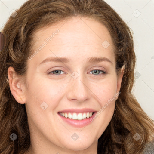 Joyful white young-adult female with long  brown hair and green eyes