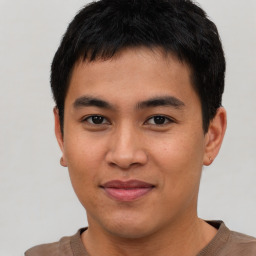 Joyful asian young-adult male with short  brown hair and brown eyes