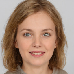 Joyful white young-adult female with medium  brown hair and blue eyes