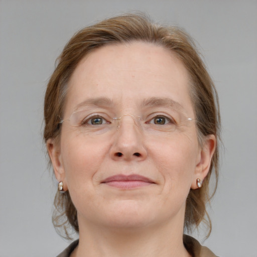 Joyful white adult female with medium  brown hair and grey eyes