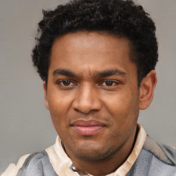 Joyful latino young-adult male with short  brown hair and brown eyes