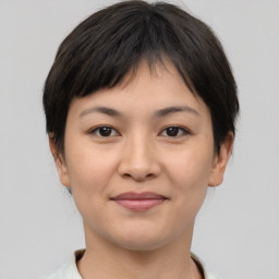 Joyful asian young-adult female with short  brown hair and brown eyes