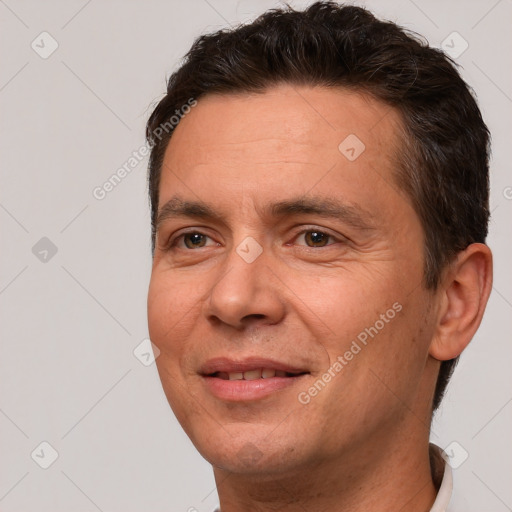 Joyful white adult male with short  brown hair and brown eyes