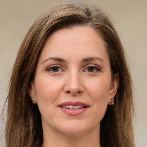 Joyful white young-adult female with long  brown hair and green eyes