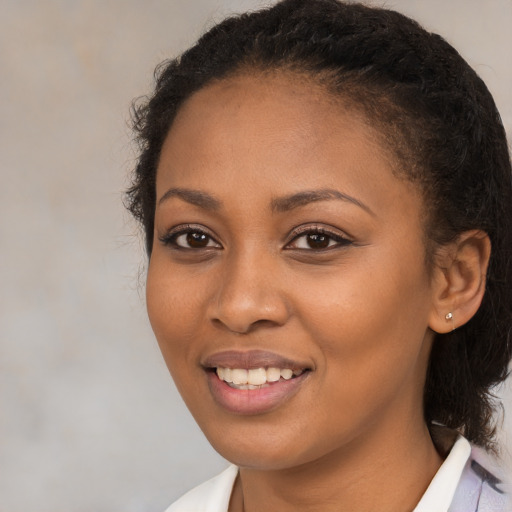 Joyful black young-adult female with medium  brown hair and brown eyes