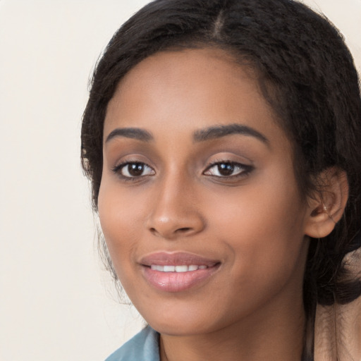 Joyful latino young-adult female with long  black hair and brown eyes