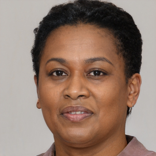 Joyful black adult female with short  brown hair and brown eyes
