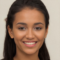 Joyful latino young-adult female with long  brown hair and brown eyes