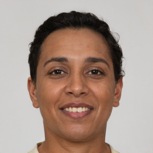 Joyful latino adult female with short  brown hair and brown eyes