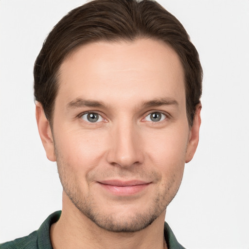 Joyful white young-adult male with short  brown hair and grey eyes