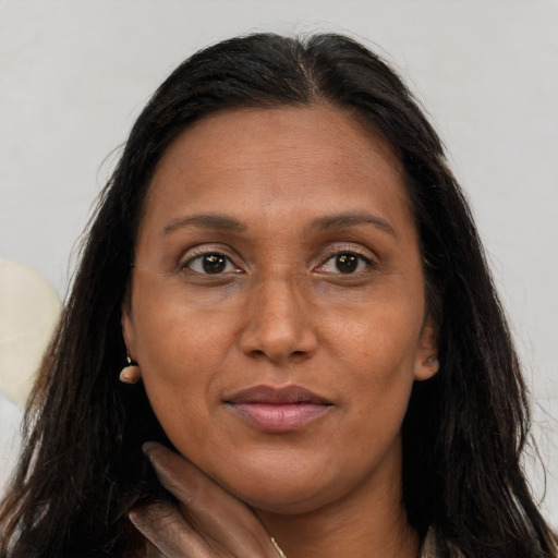 Joyful white adult female with long  brown hair and brown eyes