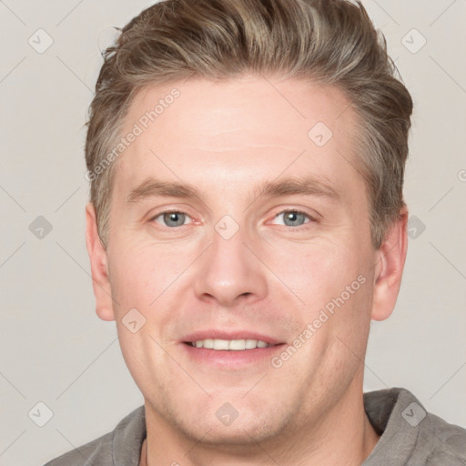 Joyful white adult male with short  brown hair and grey eyes