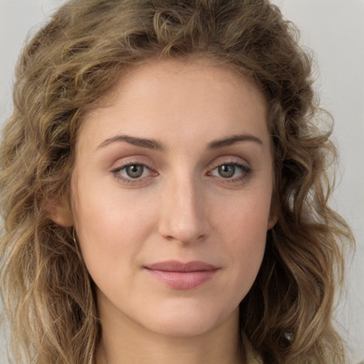 Joyful white young-adult female with long  brown hair and green eyes