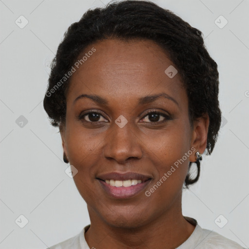 Joyful black adult female with short  black hair and brown eyes