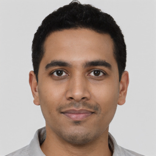 Joyful latino young-adult male with short  black hair and brown eyes